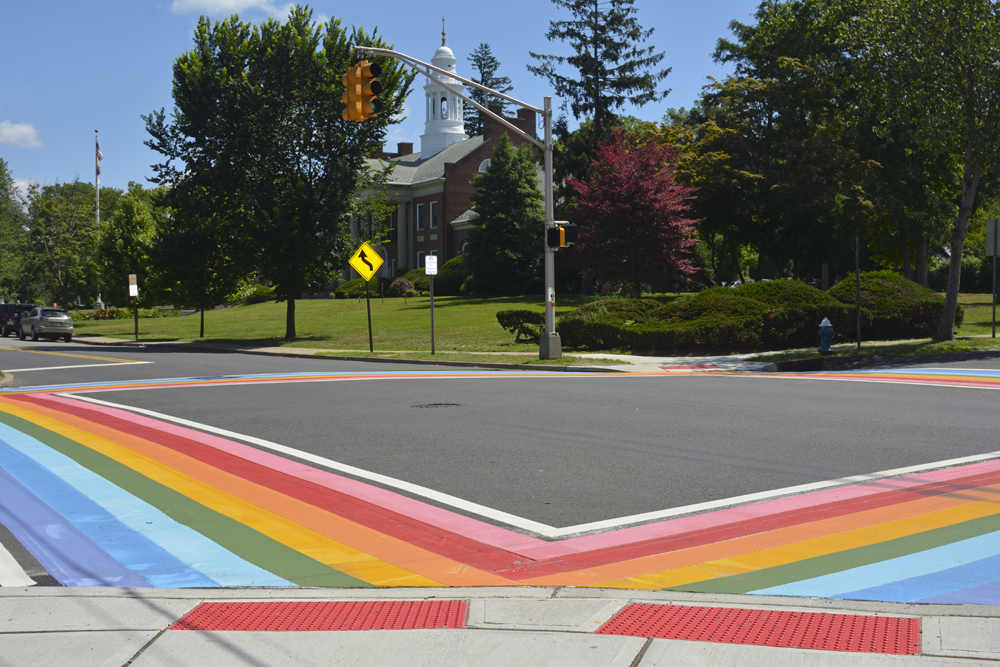 Maplewood, NJ June 2018 - Crosswalk painted in pink, red, orange, yellow, green, light blue and blue to symbolize that LGBTQ pride should be celebrated every day - Maplewood Municipal Buiding is also in this photograph